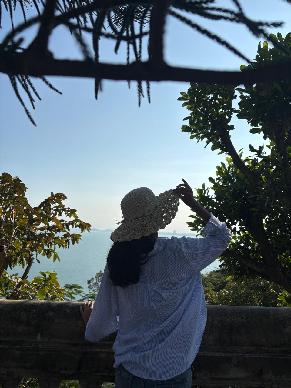 Freya looking out at the sea through the trees